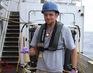 Ben Van Mooy with a water sample from Gulf of Mexico after oil spill